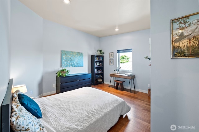 bedroom with baseboards, recessed lighting, and wood finished floors