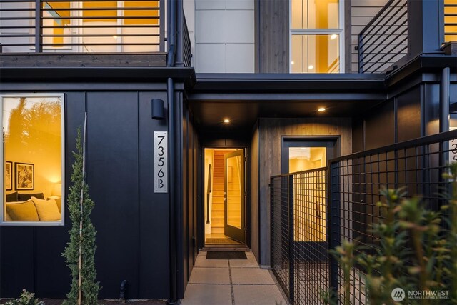 property entrance with fence and a balcony