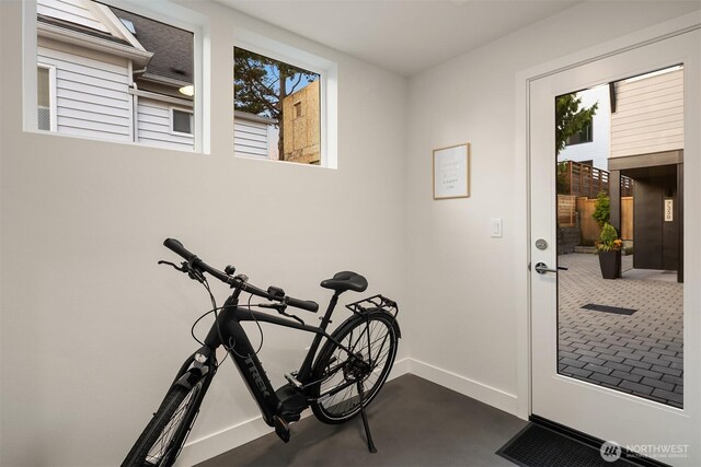 doorway to outside with baseboards and a wealth of natural light