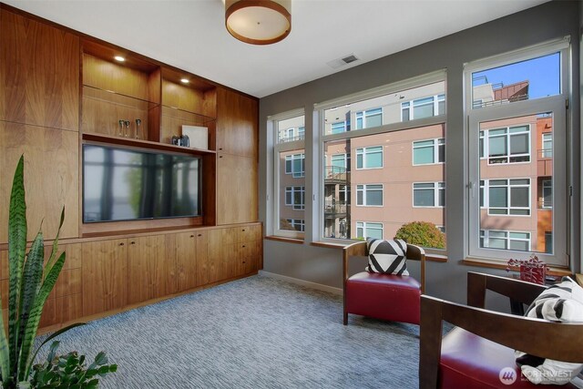 sitting room featuring baseboards, carpet flooring, and visible vents
