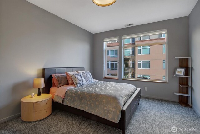 bedroom featuring baseboards, carpet flooring, and visible vents