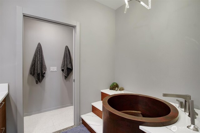bathroom with a tub and vanity
