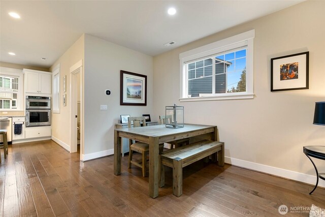 dining area with recessed lighting, baseboards, and dark wood finished floors