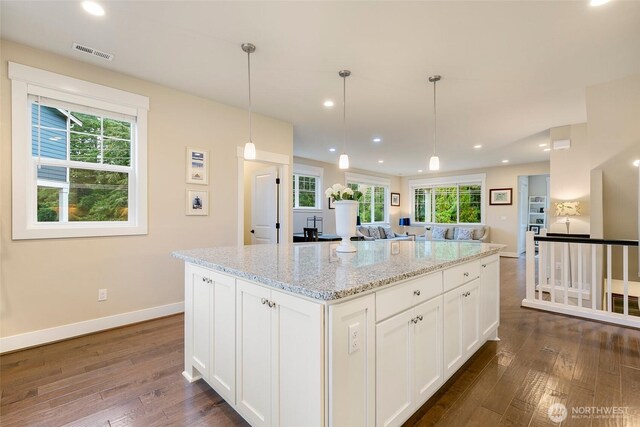 kitchen with baseboards, dark wood-type flooring, white cabinetry, and visible vents