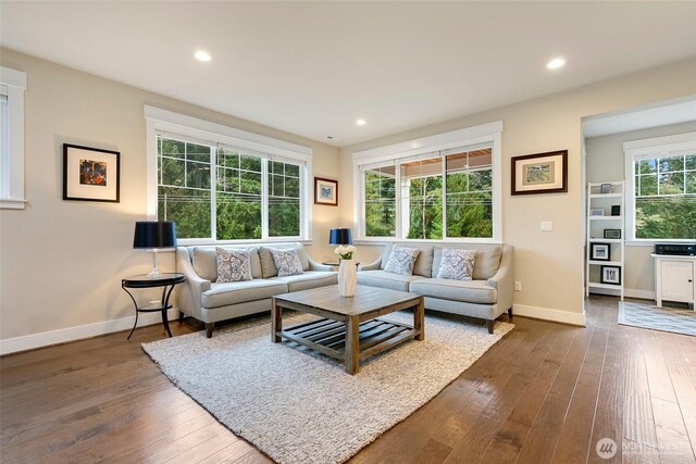 living room featuring baseboards, recessed lighting, and dark wood finished floors