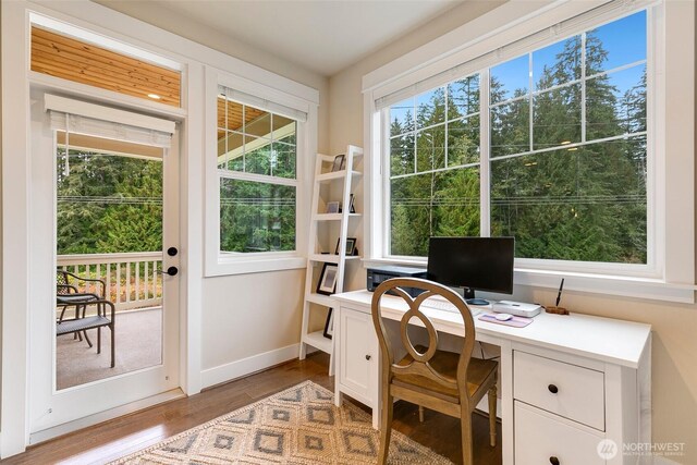 office area with baseboards and wood finished floors