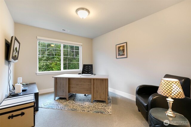carpeted office featuring baseboards and visible vents