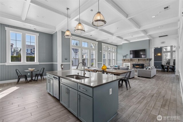 kitchen featuring a sink, coffered ceiling, gray cabinetry, and light wood-style flooring