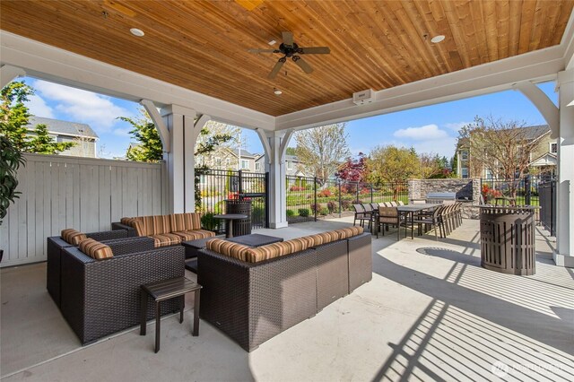 view of patio with outdoor dining area, a fenced backyard, a ceiling fan, and an outdoor hangout area