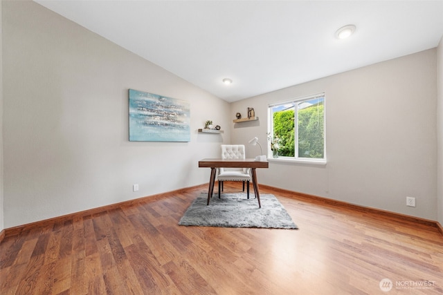home office with baseboards, vaulted ceiling, and wood finished floors
