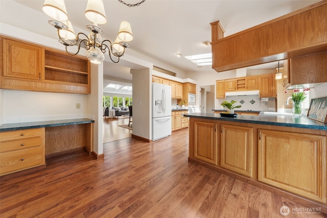 kitchen featuring open shelves, dark countertops, white appliances, a chandelier, and dark wood-type flooring