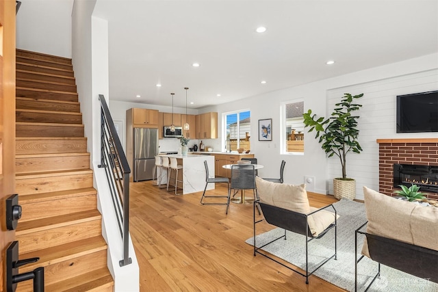 8018 24th Ave NW, Seattle, WA 98117 - living room featuring stairway, light wood-type flooring, recessed lighting, and a fireplace