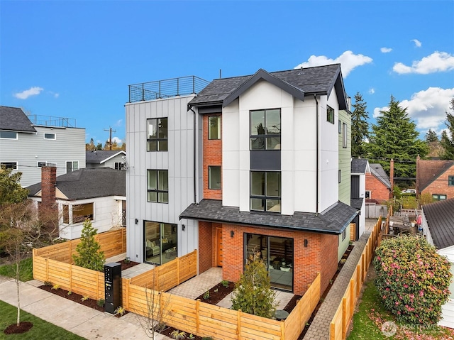 8018 24th Ave NW, Seattle, WA 98117 - view of front facade featuring a fenced front yard, brick siding, board and batten siding, and roof with shingles