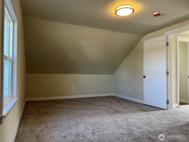 bonus room with carpet, lofted ceiling, and baseboards
