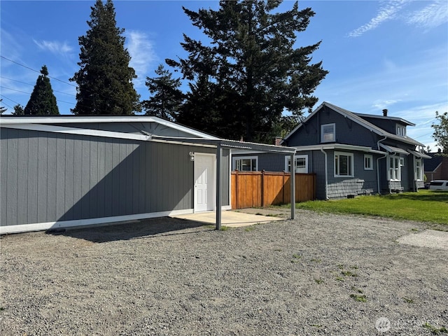 view of home's exterior featuring fence