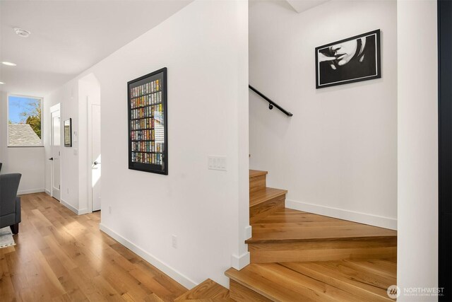stairs with baseboards and wood finished floors