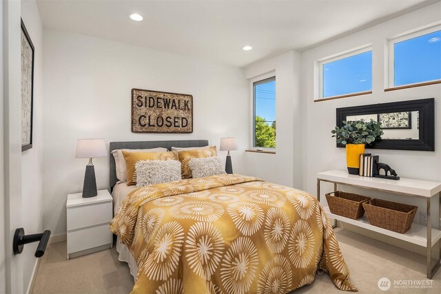 bedroom with baseboards, recessed lighting, and light carpet
