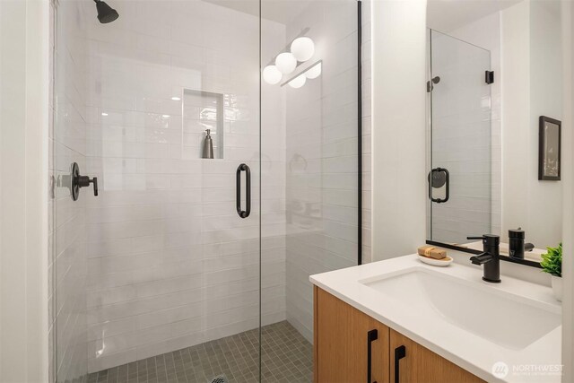 bathroom with vanity and a stall shower