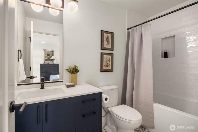 full bath with vanity, shower / bath combo, toilet, and connected bathroom