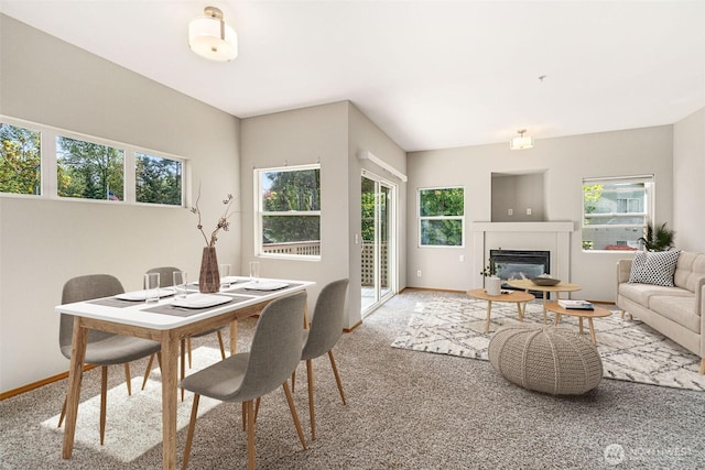 17610 134th Ln SE, Renton, WA 98058 - carpeted dining space with baseboards and a glass covered fireplace