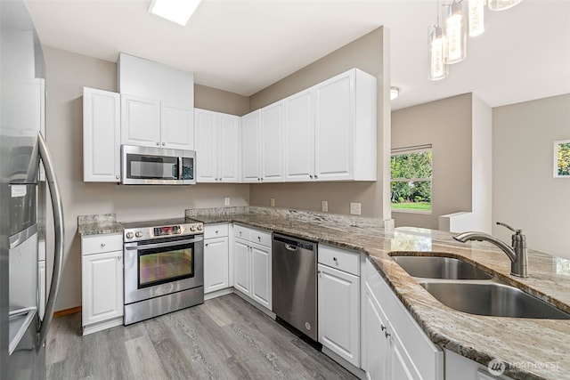 17610 134th Ln SE, Renton, WA 98058 - kitchen with white cabinets, stainless steel appliances, a sink, and light wood-style floors