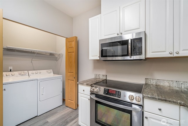17610 134th Ln SE, Renton, WA 98058 - kitchen with light wood finished floors, washing machine and dryer, white cabinets, and stainless steel appliances