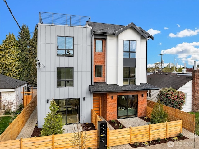 8018 24th Ave NW Unit B, Seattle, WA 98117 - view of front of home with brick siding, a gate, board and batten siding, and a fenced front yard