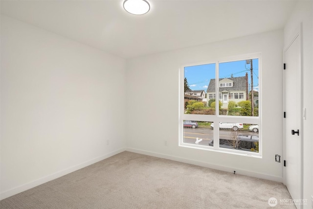 8018 24th Ave NW Unit B, Seattle, WA 98117 - spare room featuring baseboards and light colored carpet