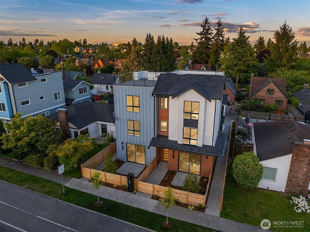 8018 24th Ave NW Unit B, Seattle, WA 98117 - view of front of home featuring a fenced front yard, board and batten siding, roof with shingles, and a residential view