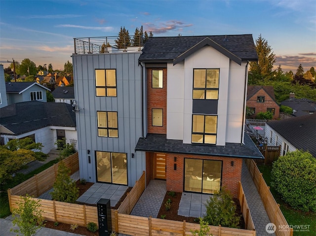 8018 24th Ave NW Unit B, Seattle, WA 98117 - view of front of house with a fenced front yard, board and batten siding, brick siding, and a patio