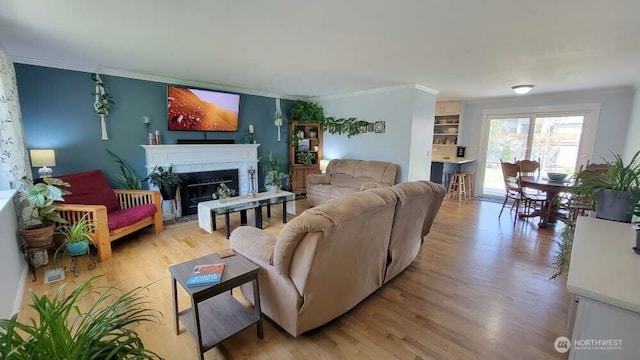 7005 226th Pl SW, Mountlake Terrace, WA 98043 - living area featuring crown molding, a fireplace with flush hearth, and light wood-style flooring