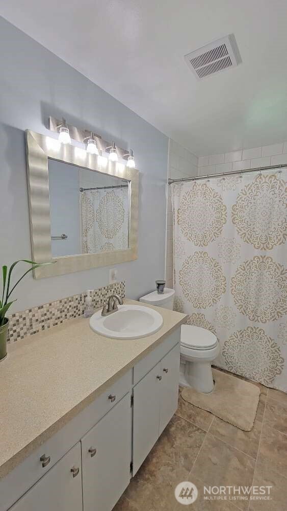 7005 226th Pl SW, Mountlake Terrace, WA 98043 - bathroom featuring tile patterned flooring, vanity, toilet, curtained shower, and visible vents