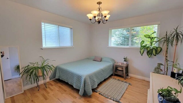 7005 226th Pl SW, Mountlake Terrace, WA 98043 - bedroom with light wood-style floors, baseboards, and a chandelier