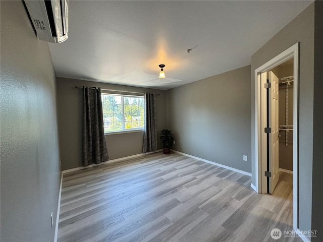 unfurnished room with baseboards and wood finished floors