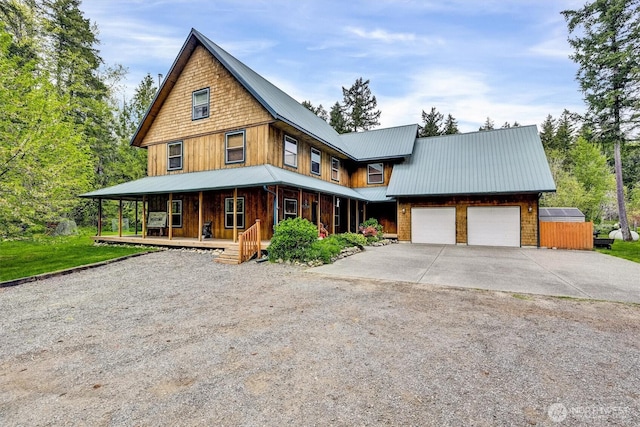 17132 156th Ln SE, Yelm, WA 98597 - view of front of property featuring an attached garage, a porch, driveway, and metal roof