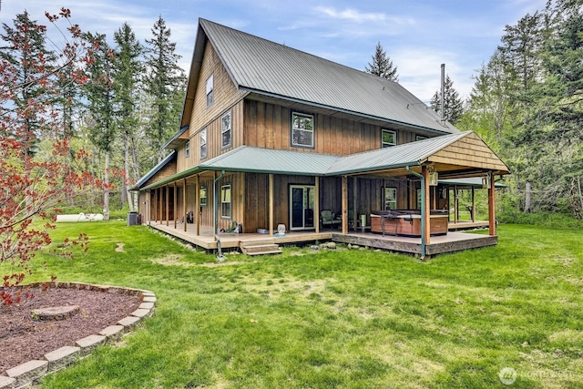 17132 156th Ln SE, Yelm, WA 98597 - back of property featuring a lawn, central AC unit, a hot tub, and metal roof