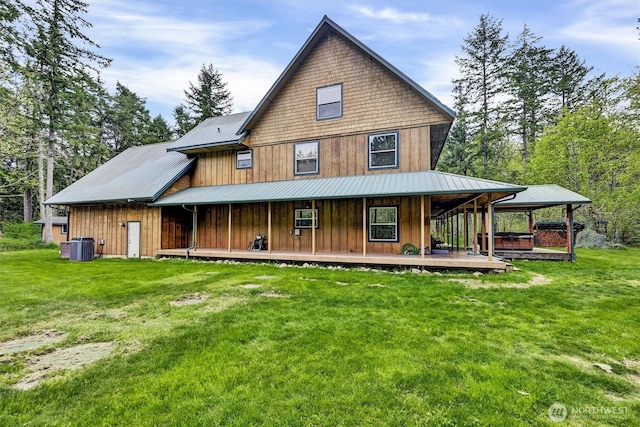 17132 156th Ln SE, Yelm, WA 98597 - back of property with board and batten siding, covered porch, metal roof, central AC, and a yard