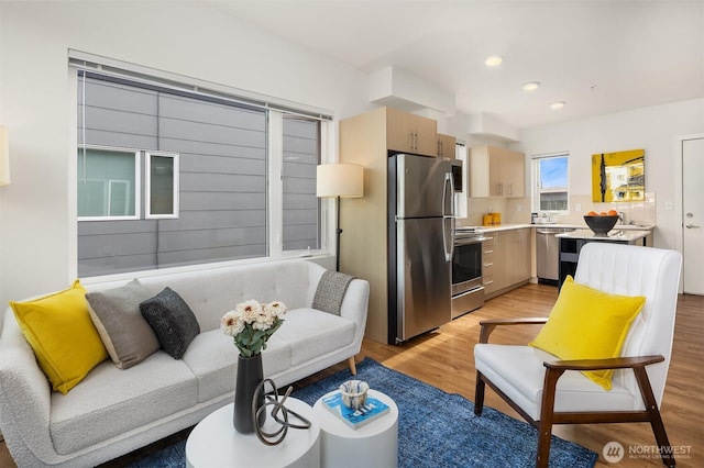 121 12th Ave E Unit 506, Seattle, WA 98102 - living room featuring light wood-style flooring and recessed lighting
