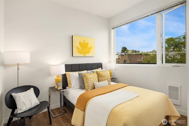 121 12th Ave E Unit 506, Seattle, WA 98102 - bedroom with wood finished floors, heating unit, and baseboards
