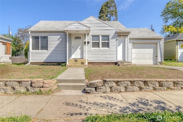 view of front of house featuring an attached garage, concrete driveway, and a shingled roof