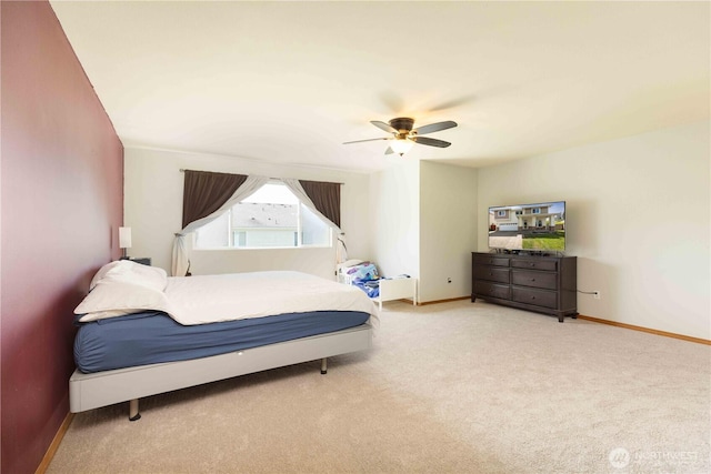 bedroom with carpet flooring, baseboards, and a ceiling fan