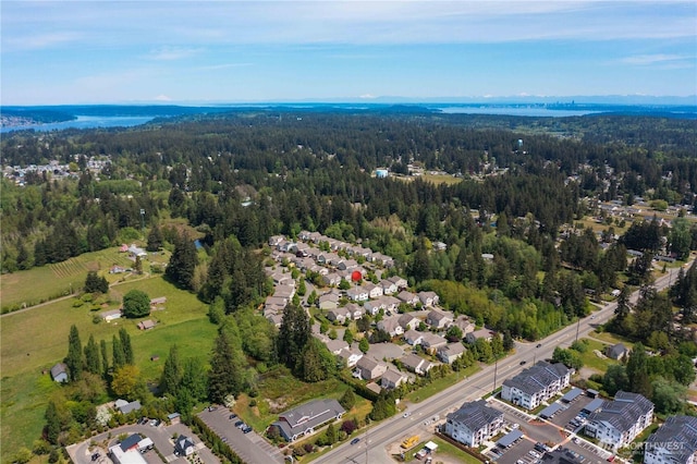 view of property location with a forest