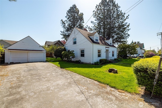 view of property exterior with a lawn, an outbuilding, and a detached garage