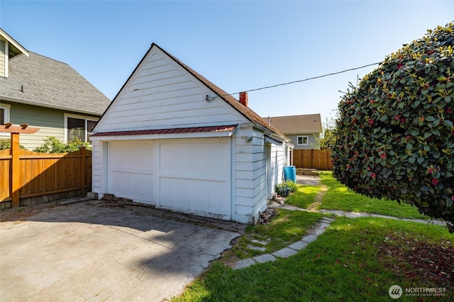 detached garage featuring fence