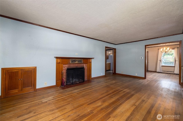 unfurnished living room featuring a textured ceiling, wood finished floors, and a chandelier
