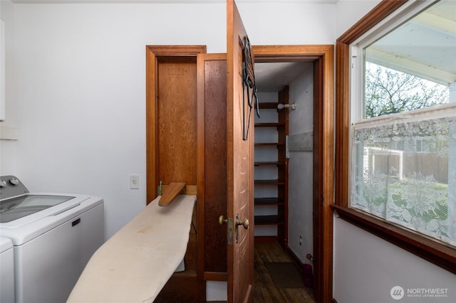 clothes washing area with laundry area, washer / dryer, and wood finished floors