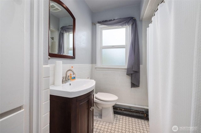 full bathroom featuring vanity, wainscoting, toilet, tile walls, and a shower with curtain