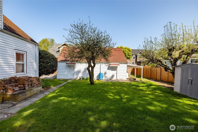 view of yard featuring a fenced backyard, an outbuilding, and a storage shed