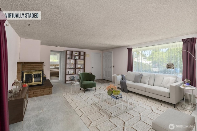 carpeted living room with a fireplace and a textured ceiling