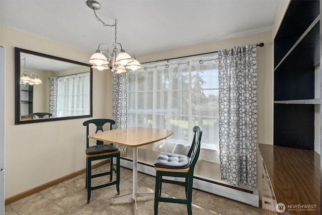 dining space with a chandelier and baseboards